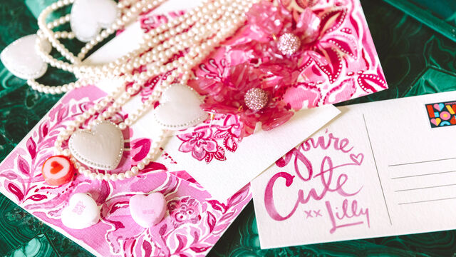 Jewelry laying on table with postcards